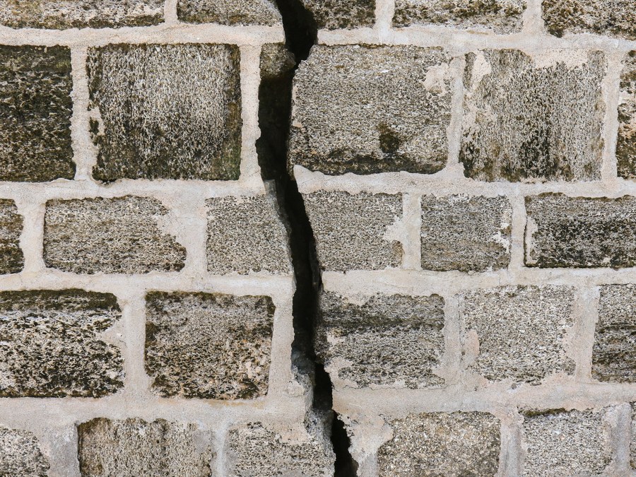 Cracked stone foundation wall